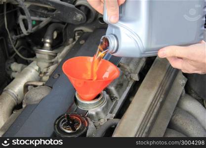 Man checking engine oil of an older car