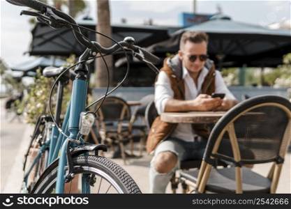 man checking his phone bike