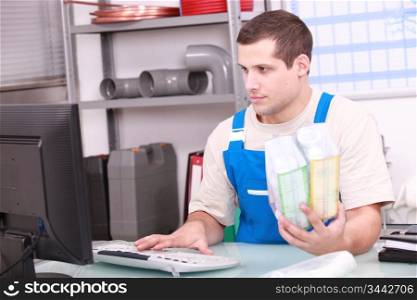 Man checking plumbing products on a computer database