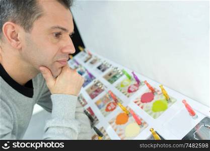 man choosing electronic cigarette from colourful display