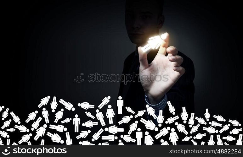 Man choosing female icon. Businessman on dark background taking with fingers female symbol