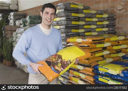 Man choosing fertilizers in gardening center