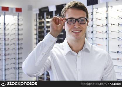Man Choosing New Glasses At Opticians