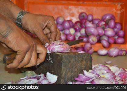 Man chopping onions in a hotel, Pune, Maharashtra, India