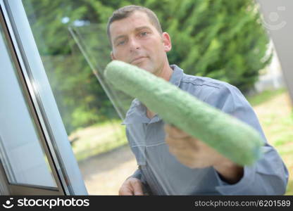 Man cleaning a window pane