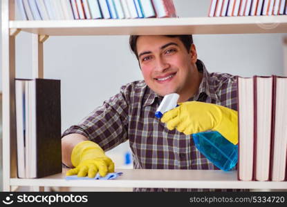 Man cleaning dust from bookshelf