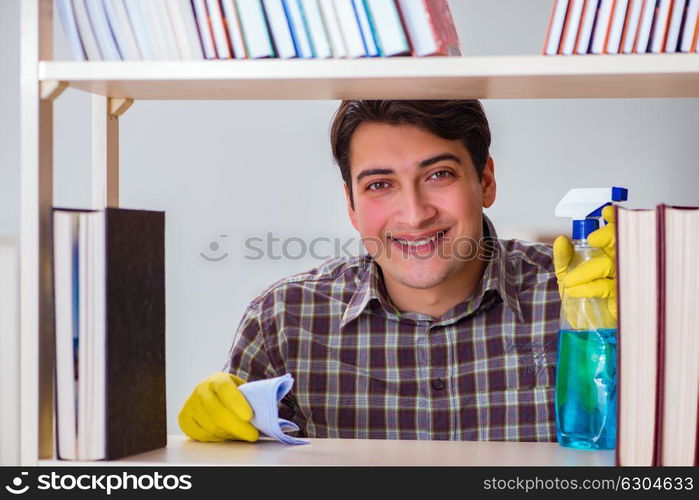 Man cleaning dust from bookshelf