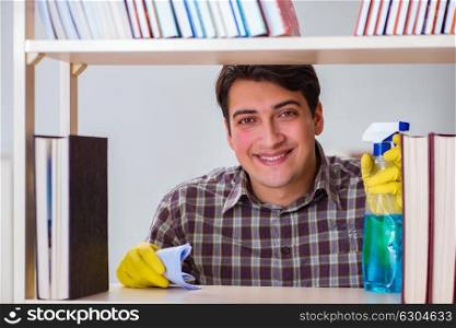 Man cleaning dust from bookshelf