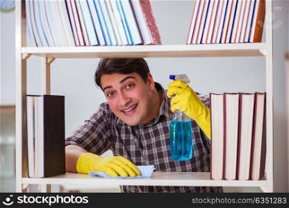 Man cleaning dust from bookshelf