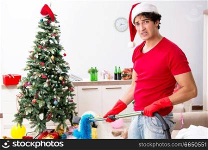 Man cleaning his apartment after christmas party