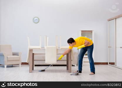 Man cleaning the house helping his wife