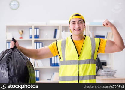 Man cleaning the office and holding garbage bag