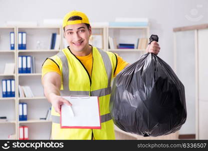 Man cleaning the office and holding garbage bag