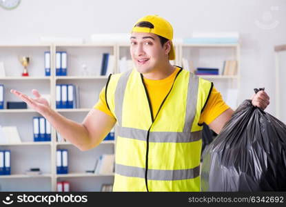 Man cleaning the office and holding garbage bag