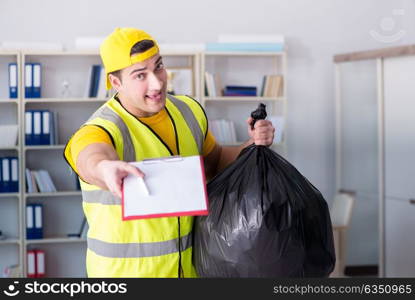 Man cleaning the office and holding garbage bag