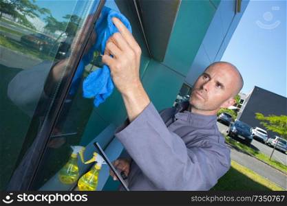 man cleaning window in his house