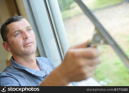 Man cleaning windows with squeegee