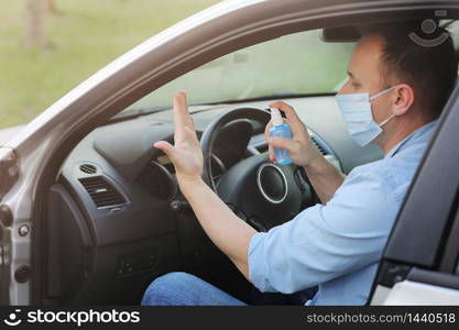 man cleans hands with antibacterial spray before traveling. infection control concept. Prevent Coronavirus, COVID-19, flu. selective focus.. man cleans hands with antibacterial spray before traveling. infection control concept. Prevent Coronavirus, COVID-19, flu. selective focus