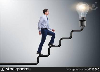 Man climbing career ladder towards bright light bulb
