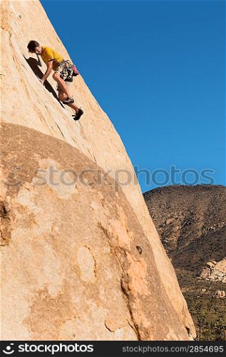 Man Climbing on Cliff