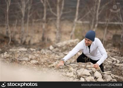 man climbing rocks nature