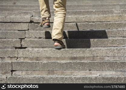 Man climbs on a concrete stairs