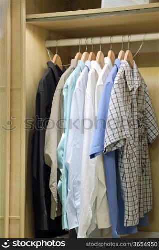 Man clothes hanging in closet