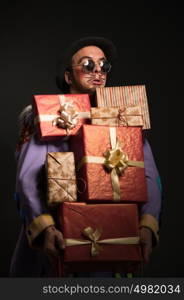 Man clown carrying a lot of Christmas gifts