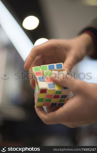 man collects the cube rubik. Intellectual puzzle