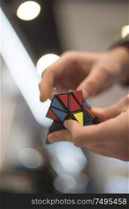 man collects the cube rubik. Intellectual puzzle