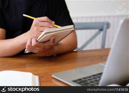 man college student studying learning lesson with computer online & taking notes