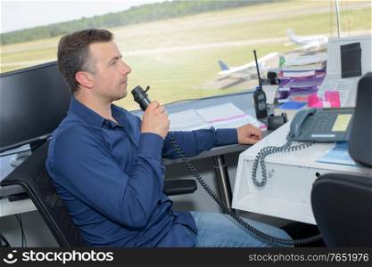 Man communicating from airport control tower