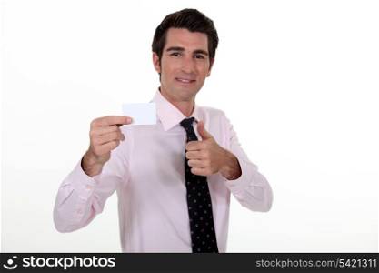 Man confidently displaying business card