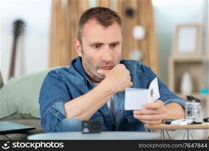 man confused with camera manual