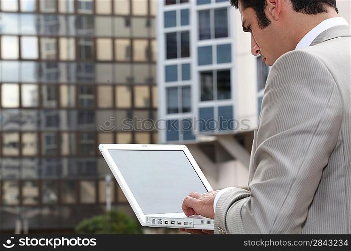 Man connecting to Internet outdoors