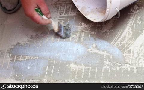 Man Construction worker is tiling at home, tile floor brush adhesive