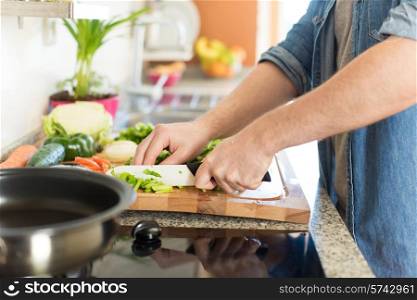 Man cooking and cutting veggies for lunch