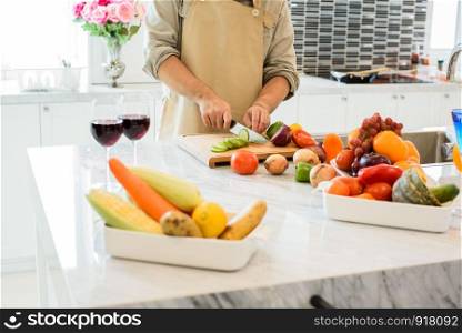 Man cooking and slicing vegetable in the kitchen. People and lifestyles concept. Food and drink theme.