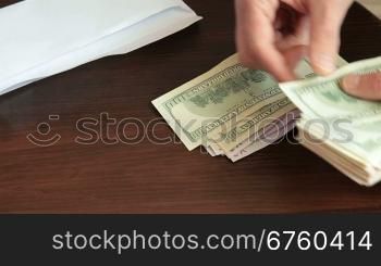 Man counting and giving cash money another man