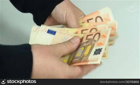 Man counts many euro banknotes in hands