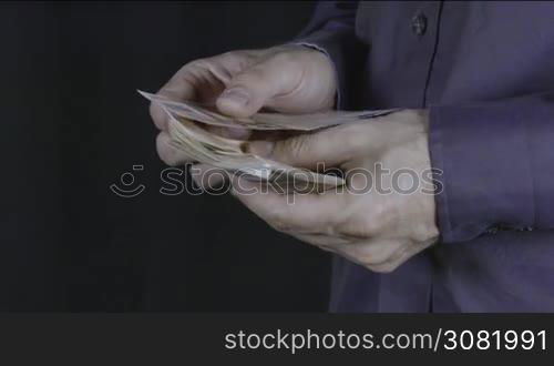 Man counts money in hands. Euro