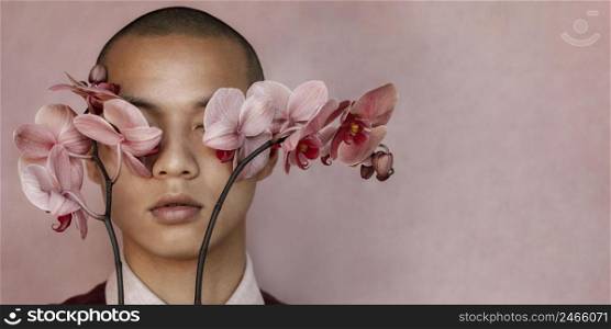 man covering eyes with flowers