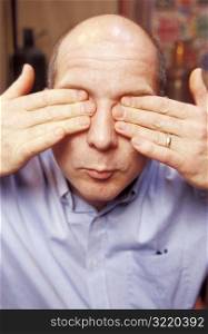 Man Covering His Eyes With His Hands