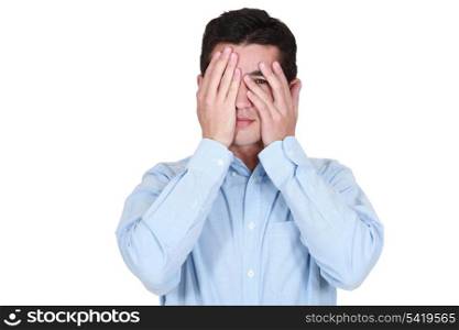 Man covering his eyes with his hands