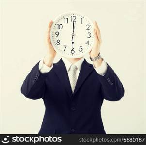 man covering his face with wall clock