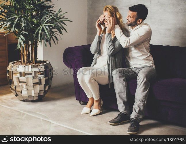 Man covering woman&rsquo;s eyes with his hands