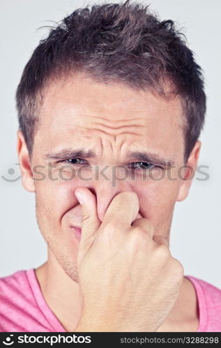 Man covers nose due to bad smell