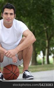Man crouching on basketball