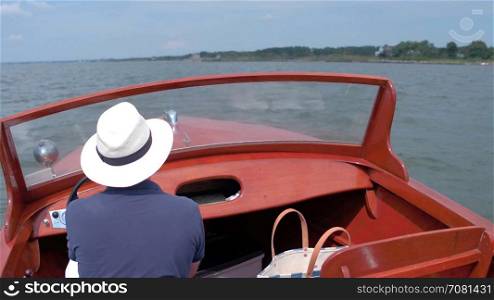 Man cruising boat on a summer day