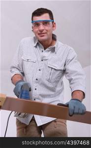 Man cutting a floorboard